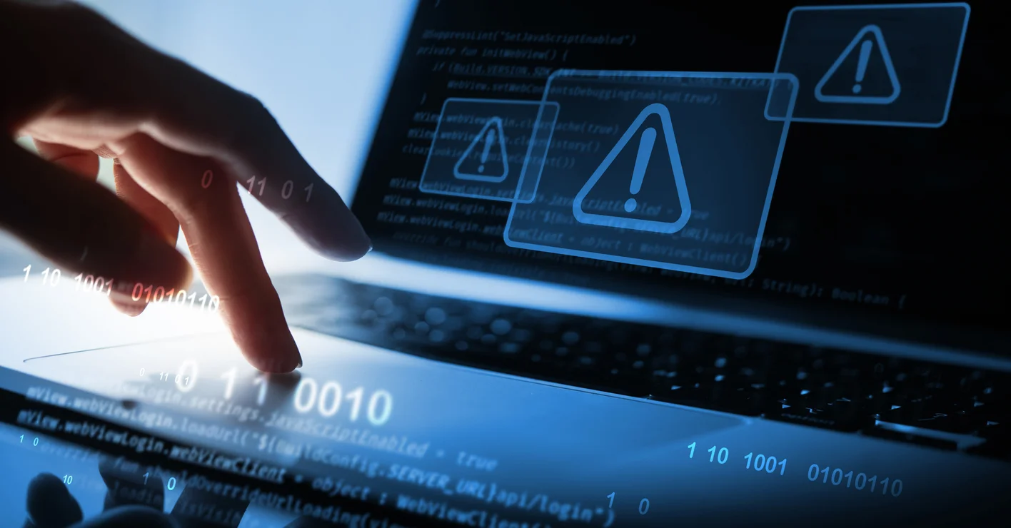 Man using computer with system hacked alert due to cyber attack on computer network.