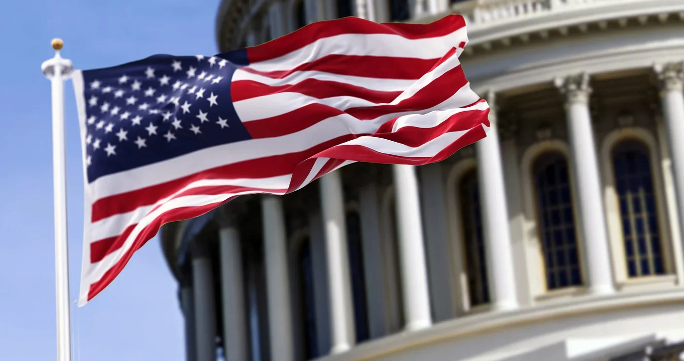 American flag waving over capital building