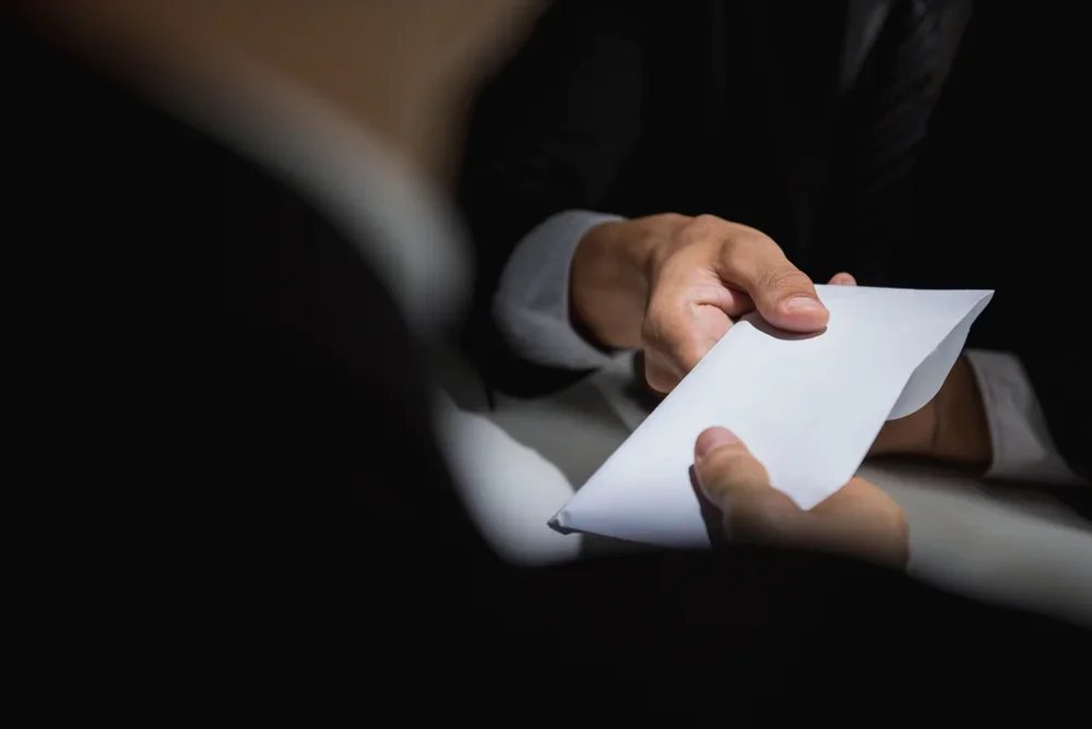 Two people exchanging documents.