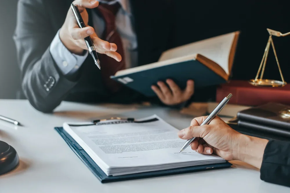 A lawyer and their client going over documents.