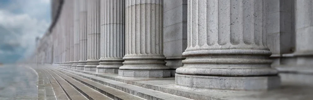 View of the steps and columns at the front of a courthouse.