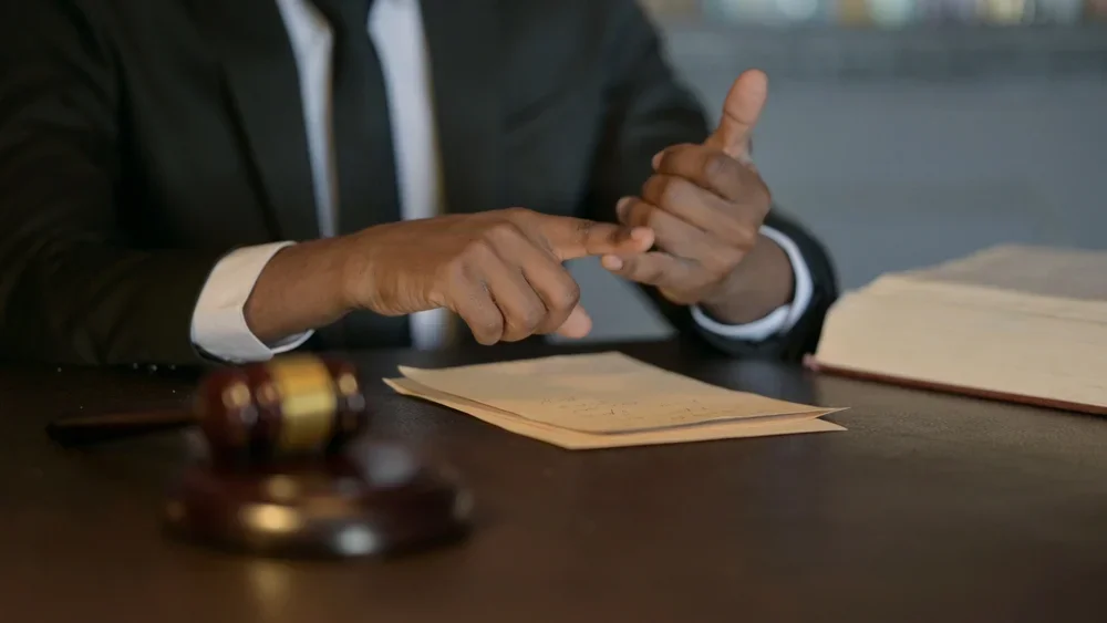 Lawyer gesturing as he discusses a case.